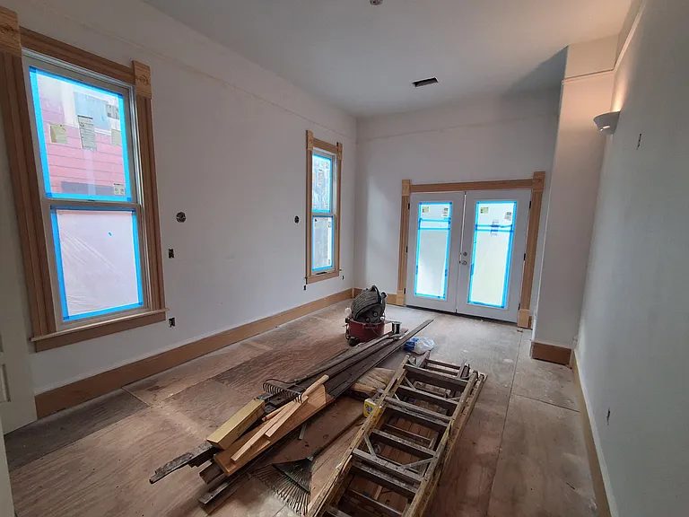 Entering large master bedroom from center hallway. Double french doors to large yard. Will have new oak floors.