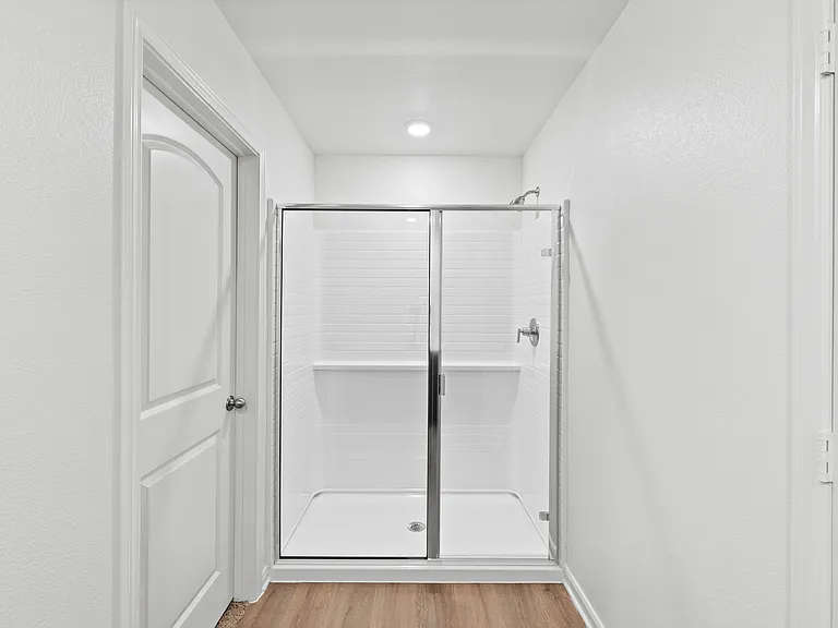 The master bathroom has a large walk-in, glass shower.