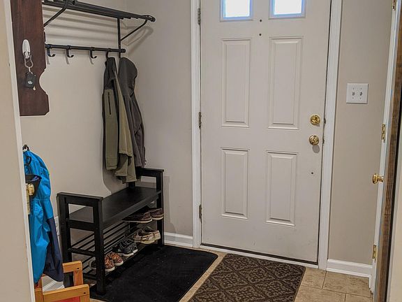 Front Entry. Two closets - a coat closet and a generously sized storage closet with shelves