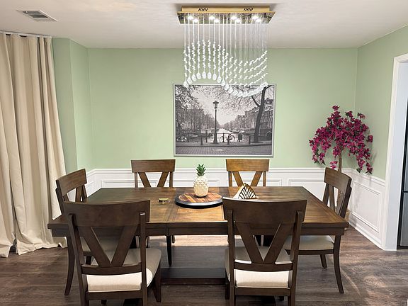 Luxury light fixture and dedicated dining room with wall paneling