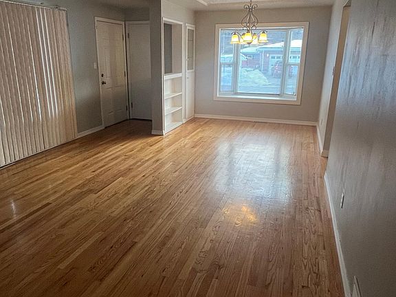 Front entrance to home, coat closet, living room and dining area