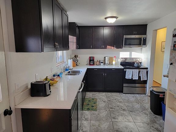 updated kitchen with expresso cabinetry and quartz counter tops. Stainless steel appliances too.
