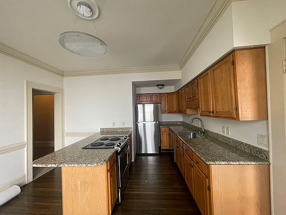 large kitchen dining room with granite counter tops and stainless appliances
