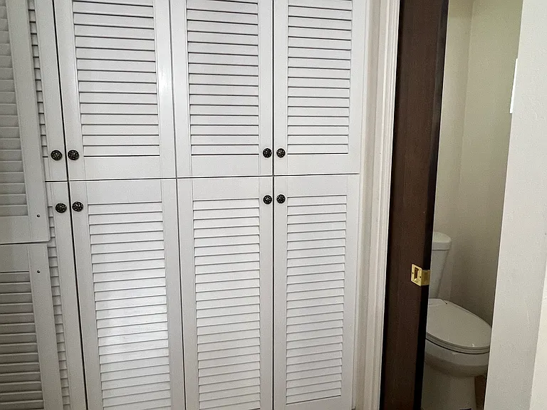 continuation of storage area and doorway to enclosed toilet.