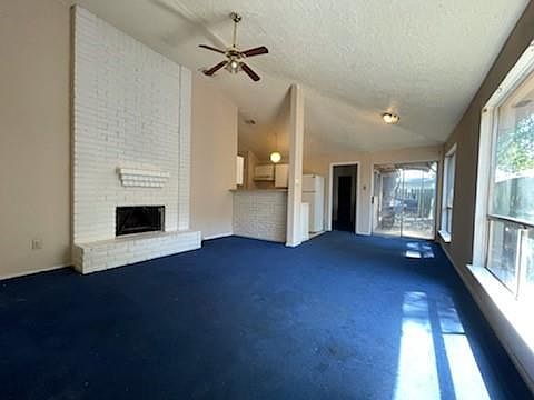 A floor to ceiling brick fireplace with hearth is sure to warm the hearts of all that gather here.