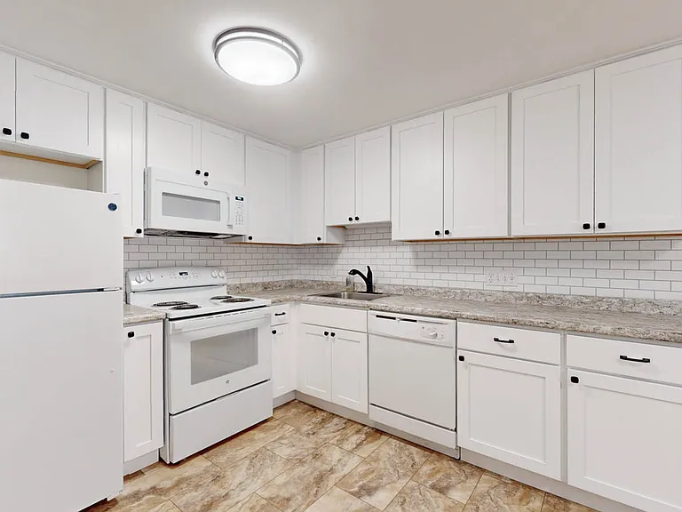 Designer cabinets with sleek new hardware. Built in Microwave!