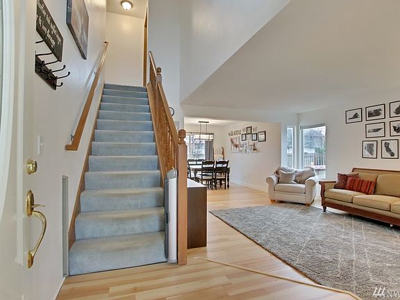 The entry opens to expansive hardwood flooring.