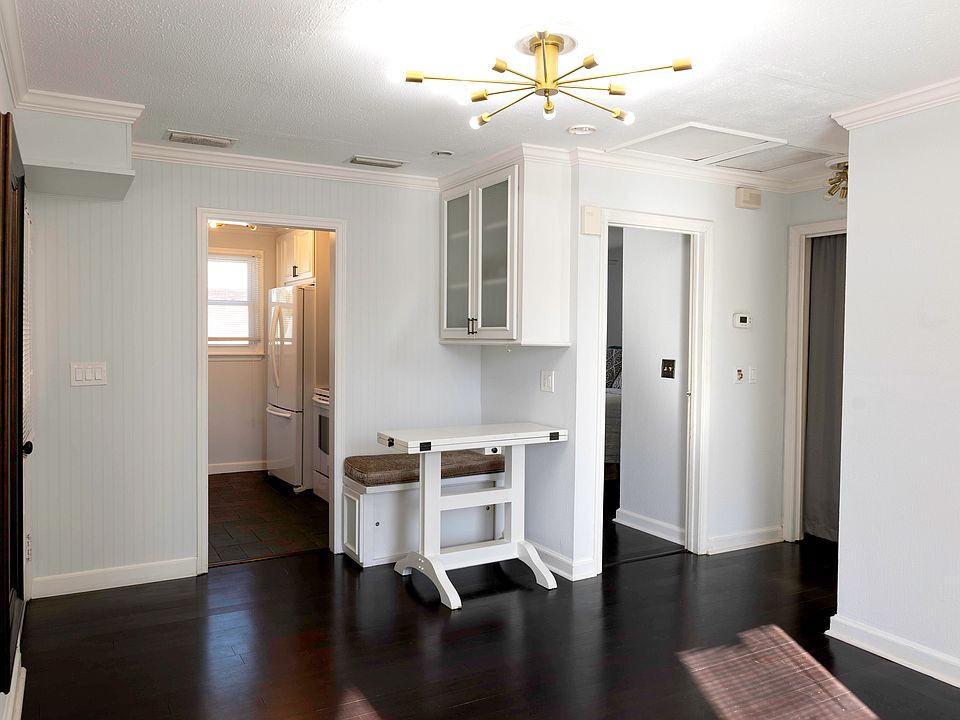View from living room of nook, kitchen, bedroom door and laundry closet