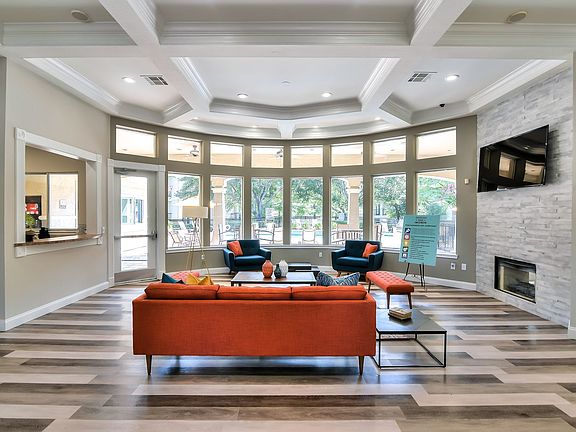 Resident lounge area with couches, television, and a cozy fire place.