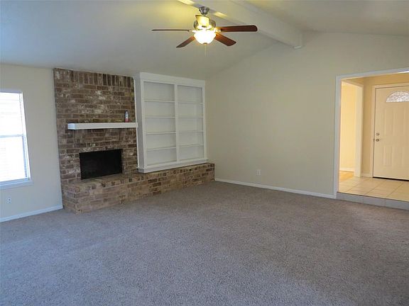 18 x 18 Main Living Area. A wood burning fireplace and book shelves add a touch of charm to the living room.Recent Paint and New Carpet!