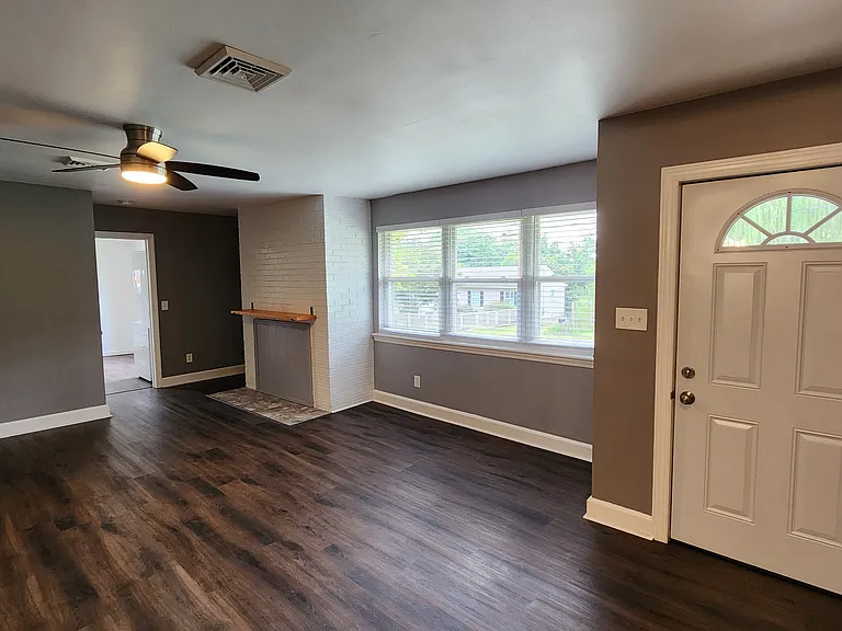 Living room looking back to bonus room/laundry