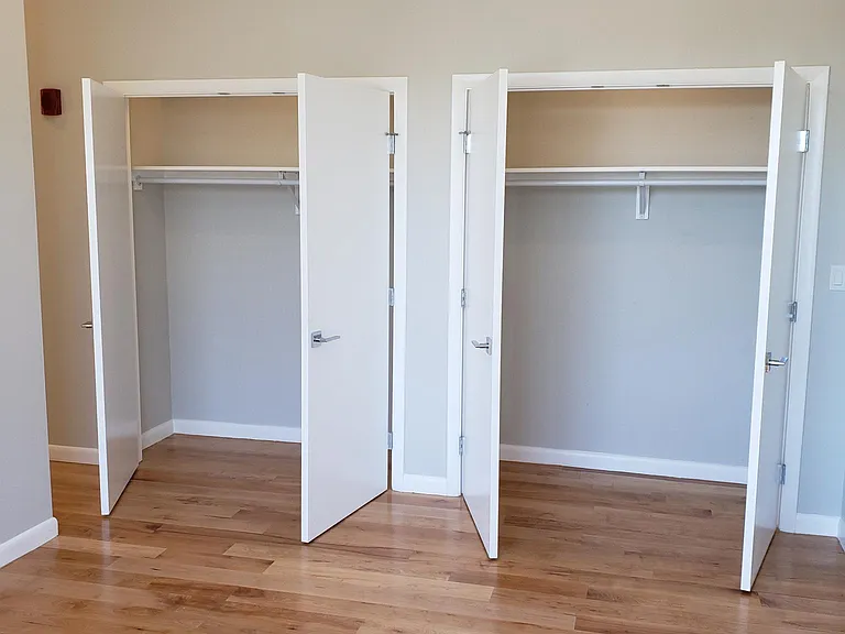 Primary bedroom, two closets. (Old flooring - photo to show closet depth.)