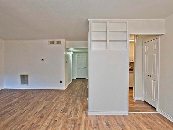 10x10 Dining Room - Looking toward living room on the left and kitchen through the door on the right. Note built-in shelving in the wall to the left of kitchen door.