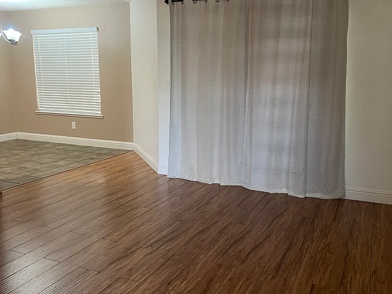 Living room area with sliding glass door to covered patio.