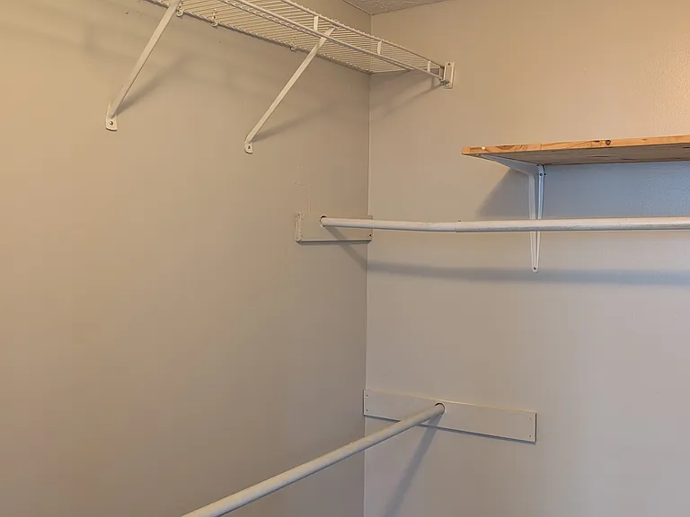 Spacious walk-in closet with built-in shelving and hanging racks