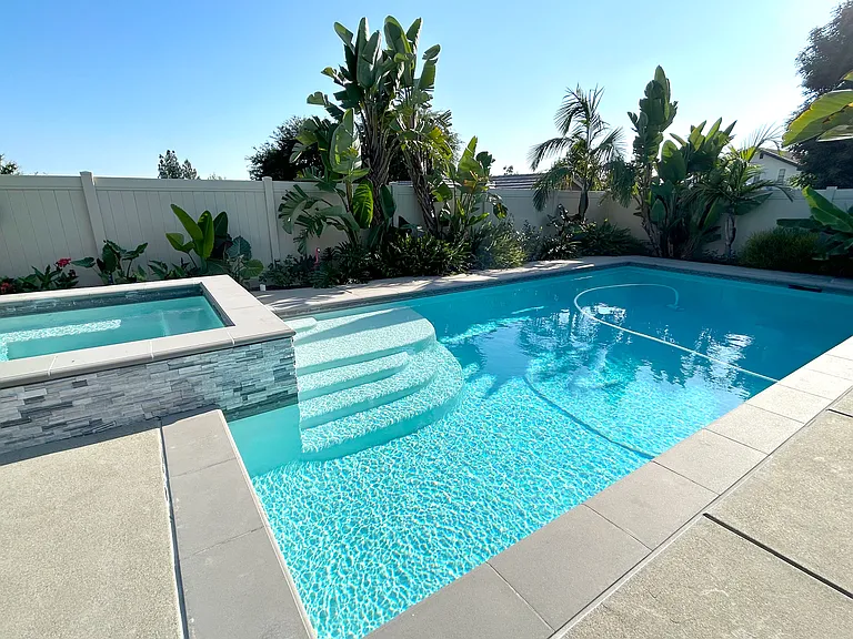 Relax on the pool's Baja shelf_a shallow ledge perfect for lounging, soaking up the sun, or keeping cool with your favorite drink nearby. Your ultimate poolside chill spot awaits!