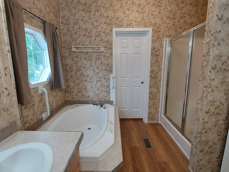 Front Master Bath features Night and Bright lighting, double vanity, huge soak tub, shower and walk-in closet.