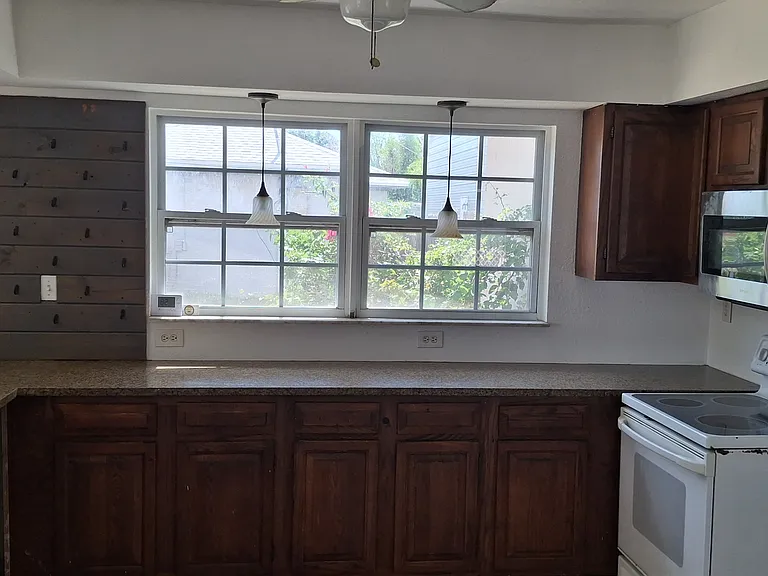 Kitchen. New fridge and dishwasher being delivered