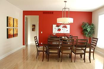 Spacious formal dining area has a wall of windows for a perfect view of the outdoors while dining.