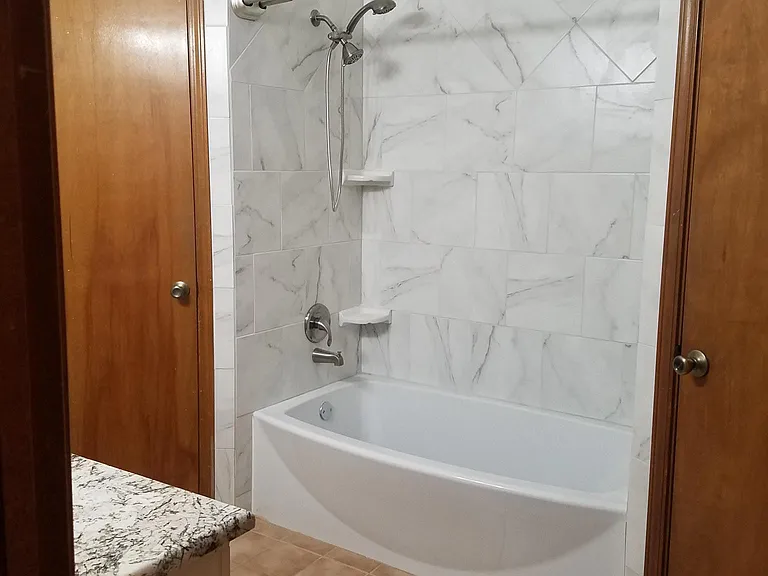 master bathroom has two walk in closets, a linen closet and a sky light.