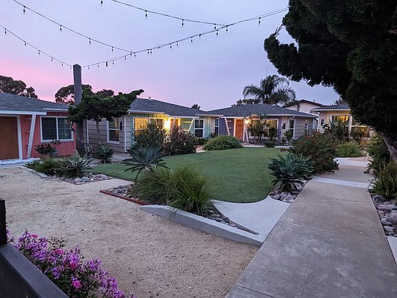 Courtyard shared by Cottages. The available home is the 1st one on the left, Salmon colored.