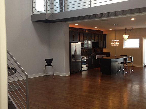 fun two story living room with skylight,fireplace,and overhe