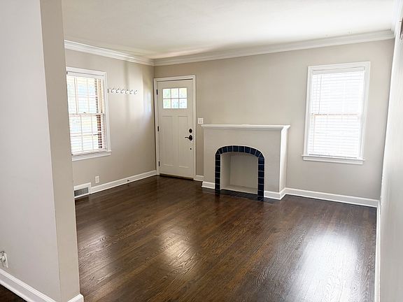 Front door and fireplace in living room