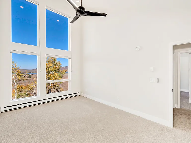 Bedroom #2 - on upper level. Floor to ceiling windows with electric black out window shades.