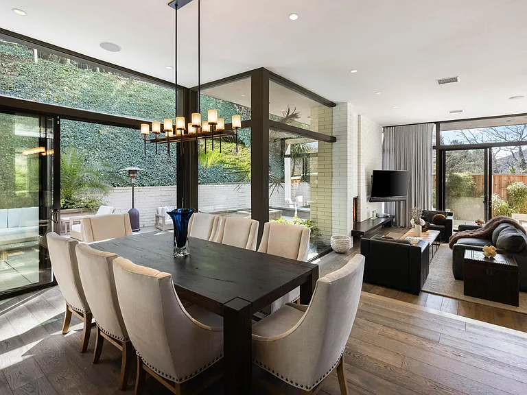 Gather around the elegant dining table, where you can savor culinary delights in a sophisticated setting.