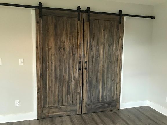 Sliding barn doors in master bedroom closet