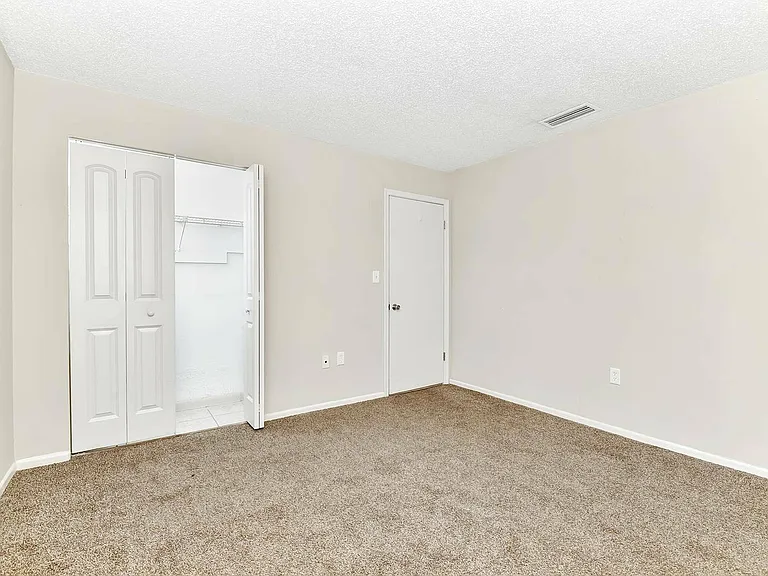 Experience tranquility in this airy bedroom, complete with modern finishes.