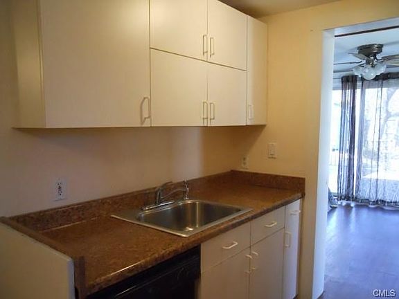 Galley kitchen leads to den