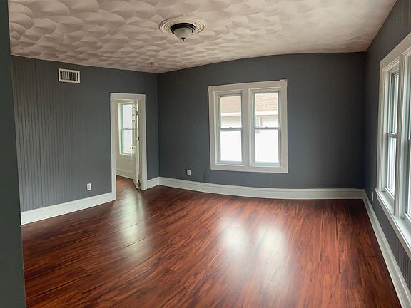 Living room space leading to master bedroom. Master bedroom is set off from the rest of the unit to provide more privacy
