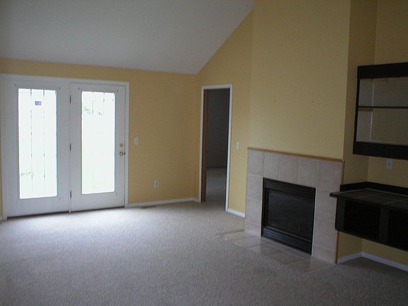 The large living area features a tall ceiling and lots of natural light.