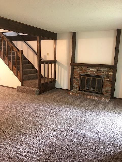 Living room has a cozy gas fireplace.