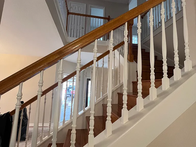View of upstairs from living room. The staircase design accentuates the high ceilings and elegant feel of the entryway and livingroom.