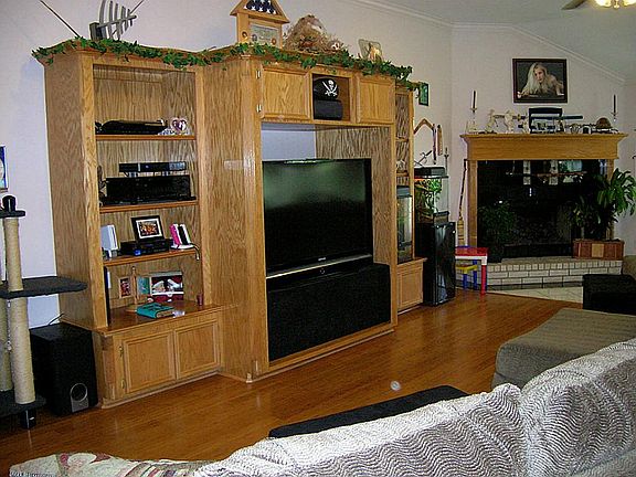 Custom built-in for your TV & media equipment, matching wood mantle.