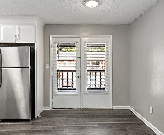 Experience elegance in this apartment's airy kitchen with stylish finishes and outdoor access.