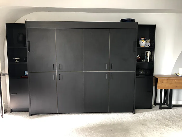 Tasteful Murphy Bed conceals your sleeping space. Uses standard queen size mattress and box spring.