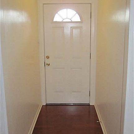 INVITING FOYER WITH DESIGNER PAINT AND GORGEOUS REAL WOOD FLOORING!