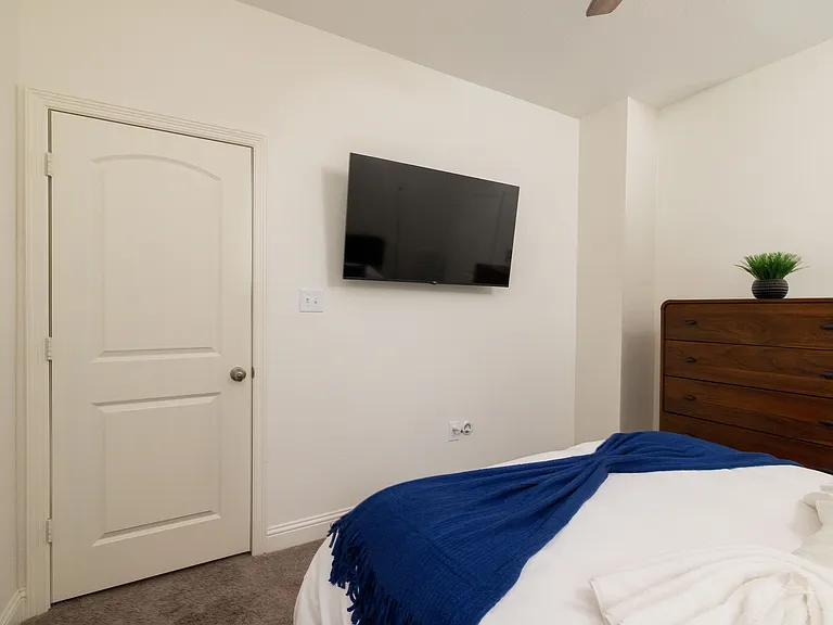 Bedroom 2 offers a cozy queen bed and a flat-screen TV_perfect for unwinding in comfort.