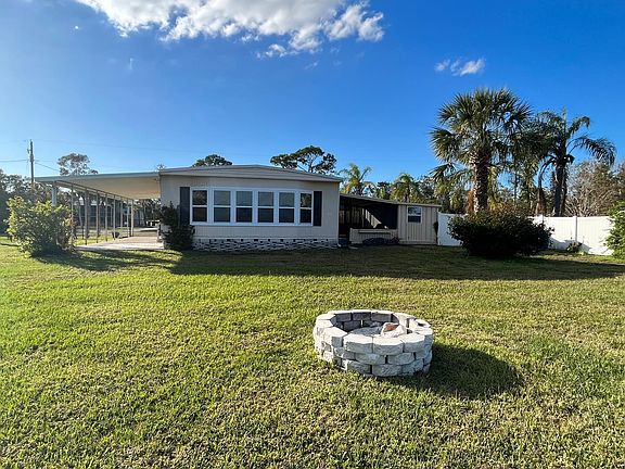 View from the sea wall on the water's edge shows the back yard and fire pit.