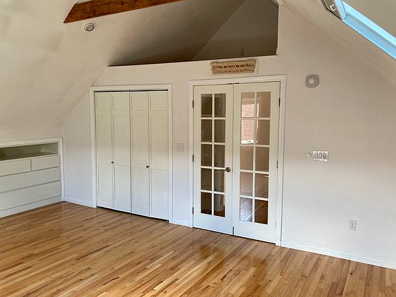 Above closet storage space in larger bedroom