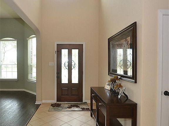 The leaded glass front door leads you into the two story entry.