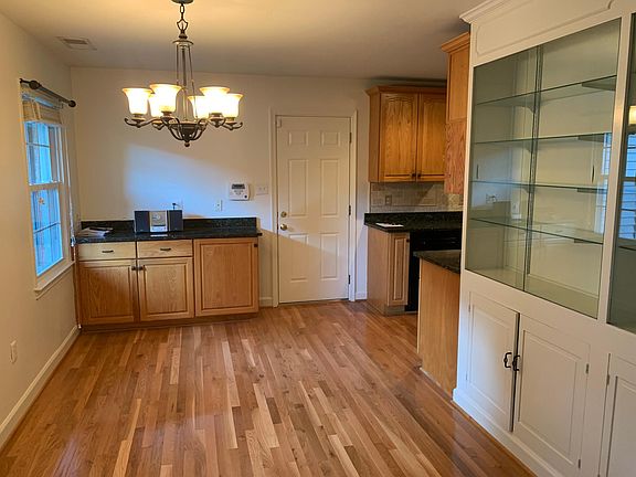 Eat-in kitchen area with custom glass front cabinets