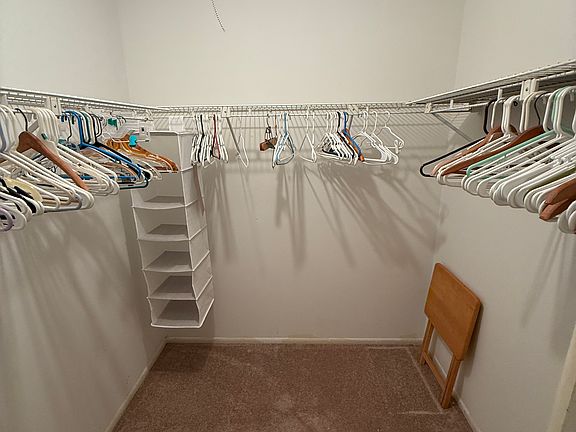 Primary bedroom walk in closet