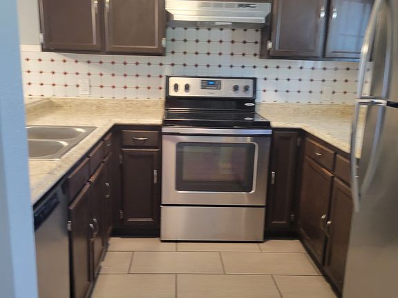 Kitchen area with all stainless steel appliances, Stove, Oven, Refrigerator, sink, disposal, dishwasher, Cabinets have been recently painted white, Nice kitchen window
