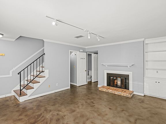 Living room with fireplace and bookcase and powder room