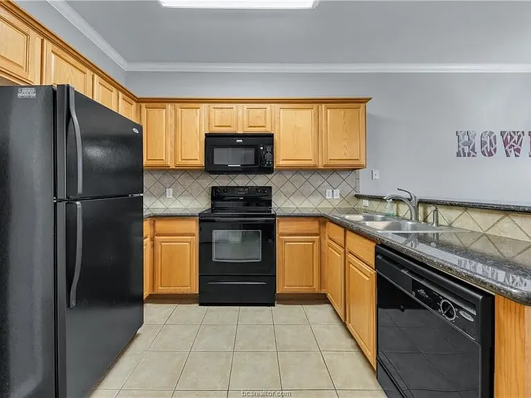 Solid wood stained cabinets. Great appliances