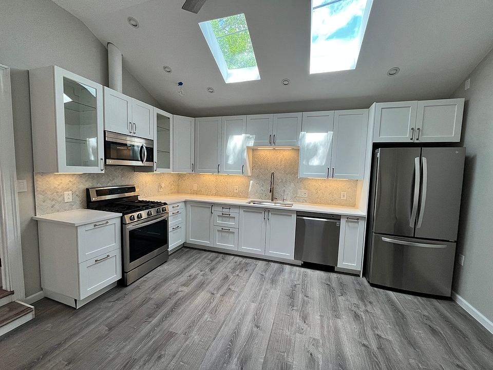 Kitchen has wonderful natural light, high ceilings, and recessed lighting.